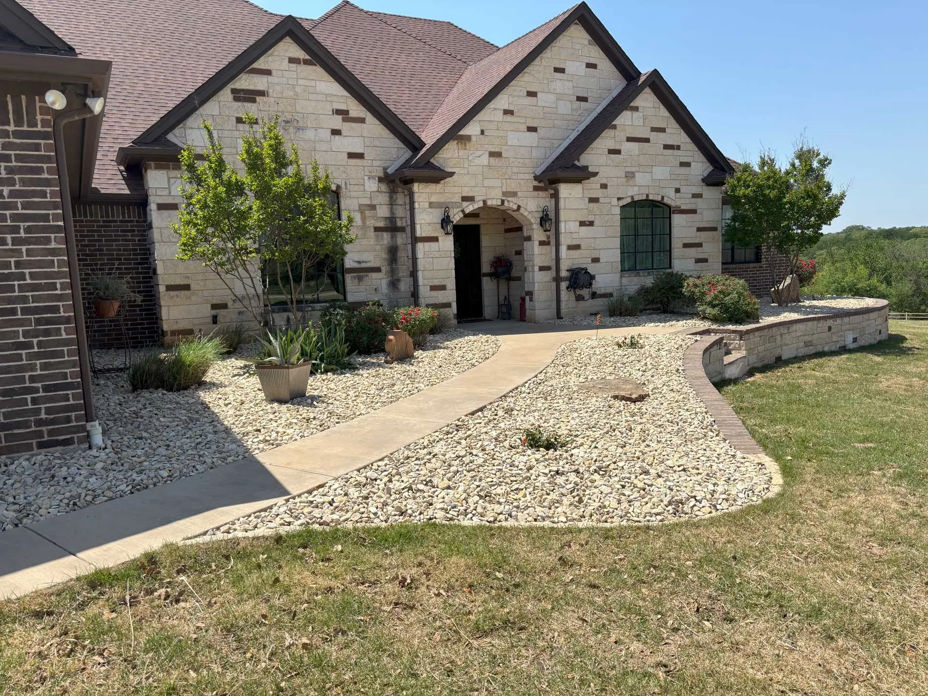 Finished rock beds and planting at a Granbury home